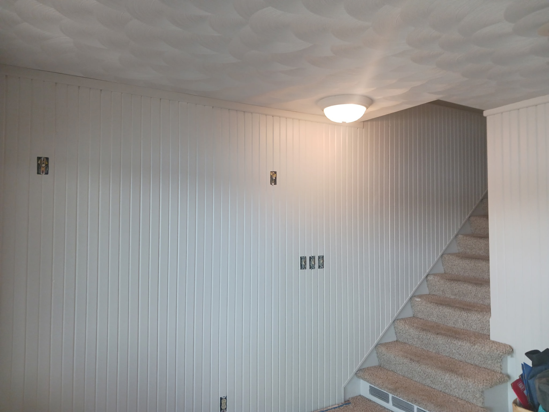 Painted knotty pine stairwell wall